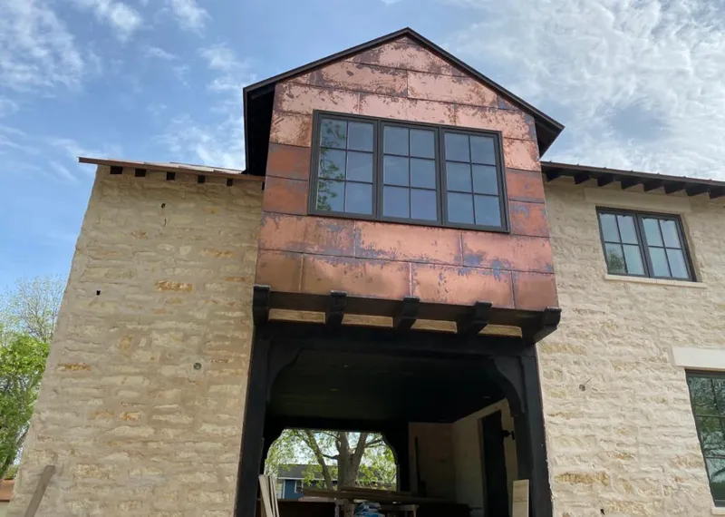 Copper metal panel facade on a stone building for Roof Repair in Three Rivers